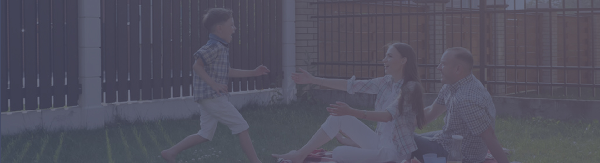 Family playing in front of a fence