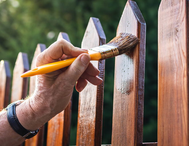 Hand staining a fence
